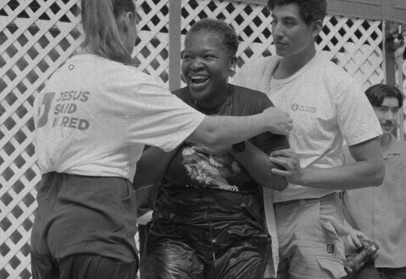 A woman being baptised in a pool
